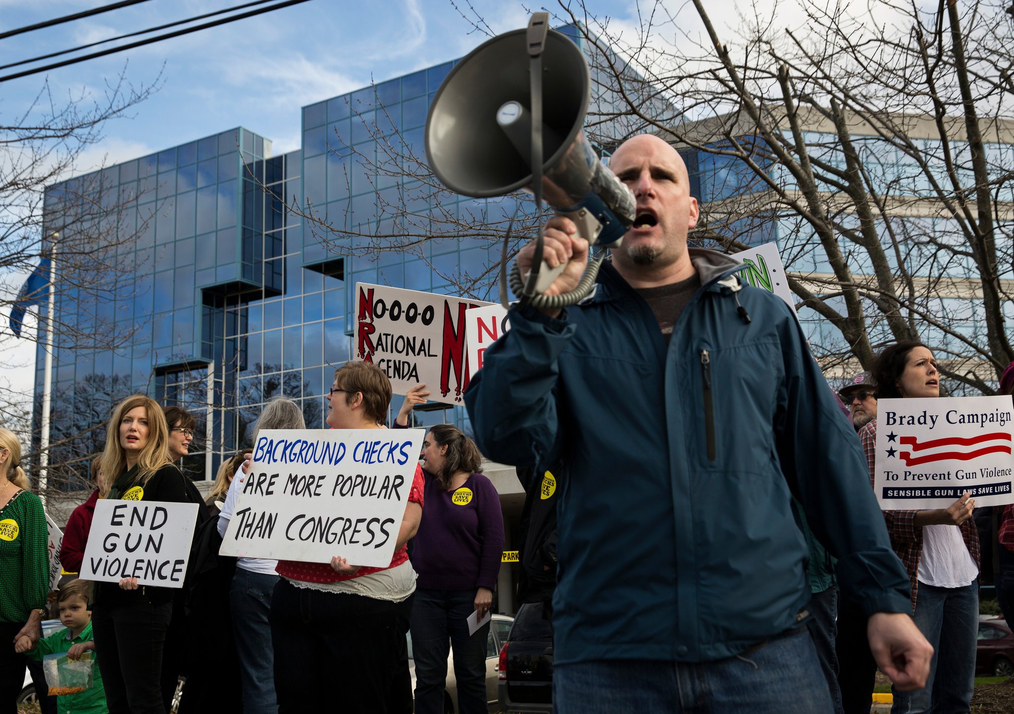 Gun control advocates protesting outside the National Rifle Association in 2015 (Photo Credit: Drew Angerer for the New York Times)